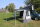 Aus Ausstellung Calicave II Markisenzelt mit Erweiterungsdreiecken-Front geschlossen mit Rolltüre-Seite 1 mit Rolltüre ohne Sichtfenster-Seite 2 mit Panoramafenster mit Verdunkelung-101  - silver gray Akzentfarbe anthracite